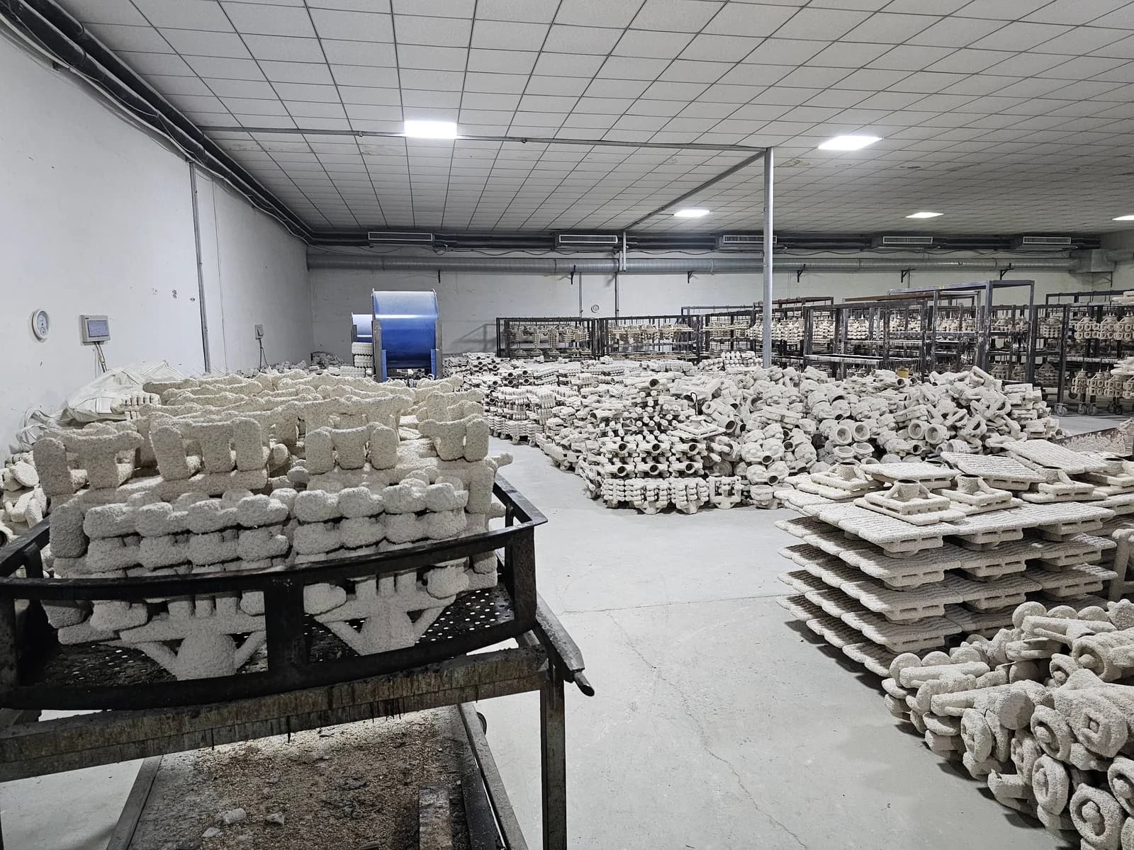 Ceramic shell molds arranged on racks in the workshop
