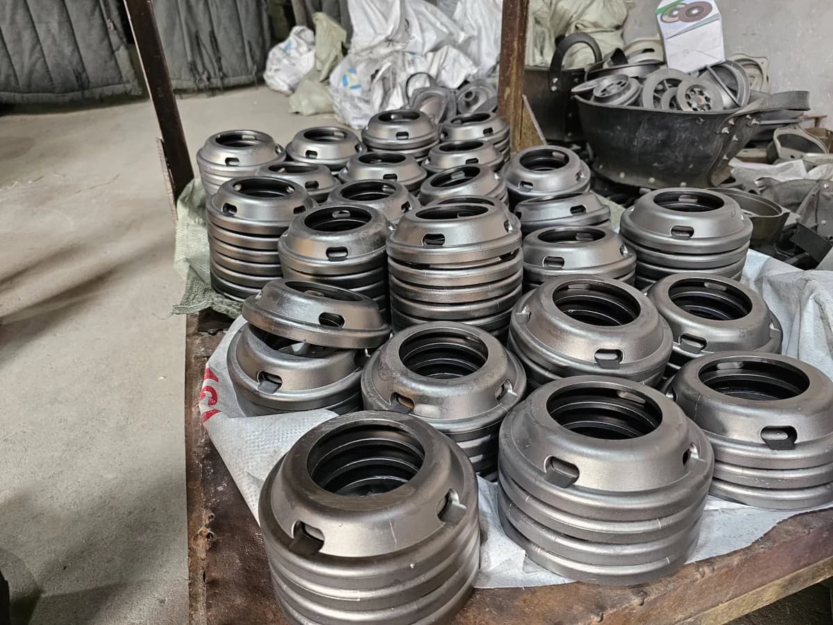 Cleaned circular cast components stacked in the workshop
