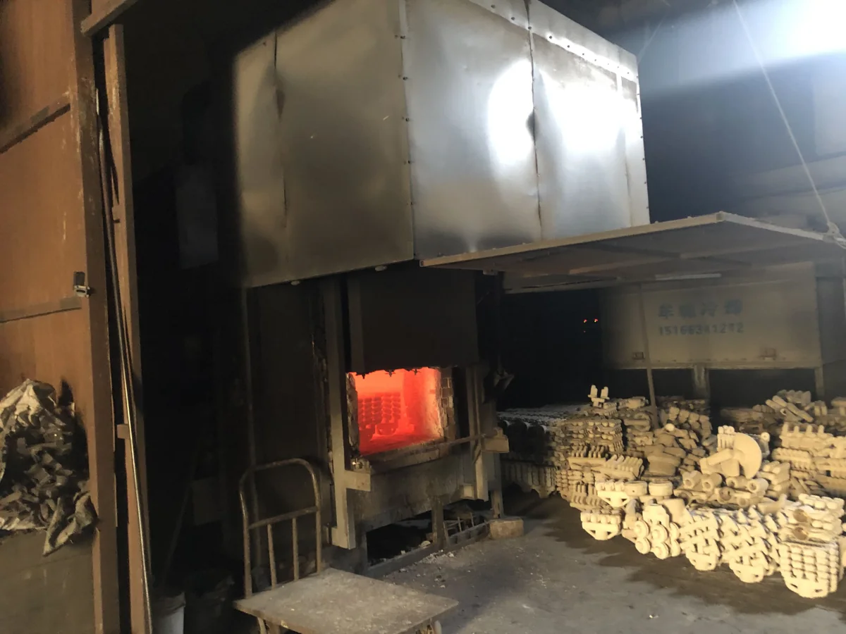 Glowing furnace opening and ceramic shell molds in the firing area