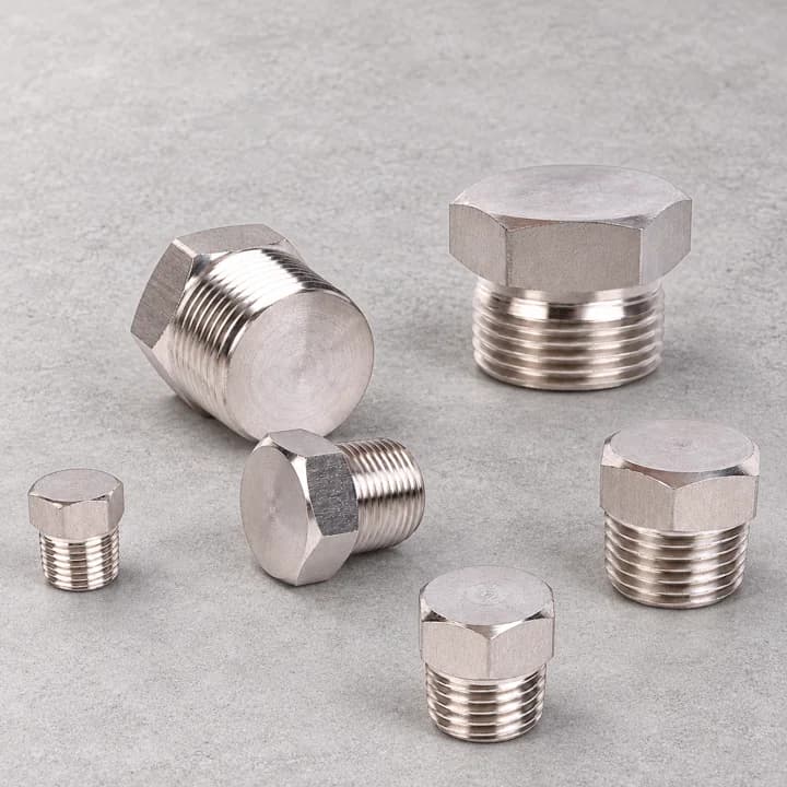 Hex-Head Threaded Plugs on a textured concrete background