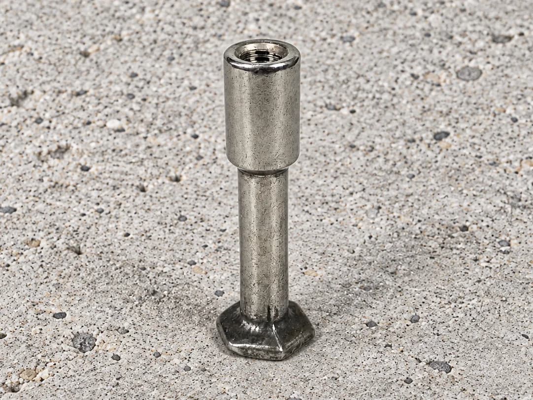 Foot anchor with an enlarged internally threaded head, a narrower smooth shank and a polygonal foot